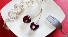 A Plate with Cherry and Tape Measure