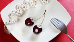 A Plate with Cherry and Tape Measure