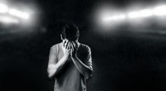 Man covering his face