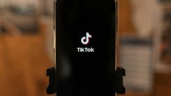 A business phone displays TikTok as it undergoes account recovery