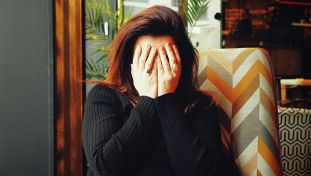Person Covering Face with Hands