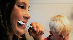 Mother and son brushing their teeth