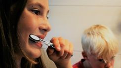 Mother and son brushing their teeth
