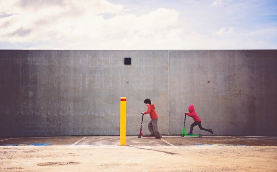 two-boys-playing-kick-scooter-551581