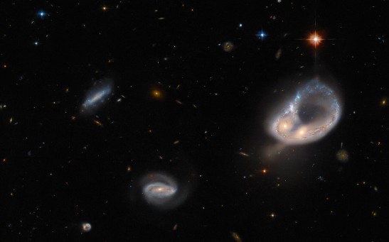 Hubble Space Telescope Captures Glowing Ring of Stars From a Pair of Entwined Galaxies