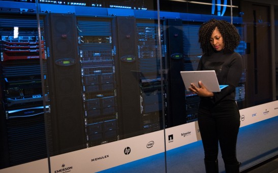 Software Engineer Standing Beside Server Racks