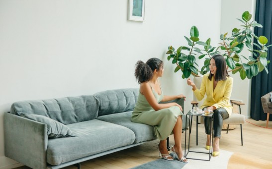 Women Sitting on Gray Couch