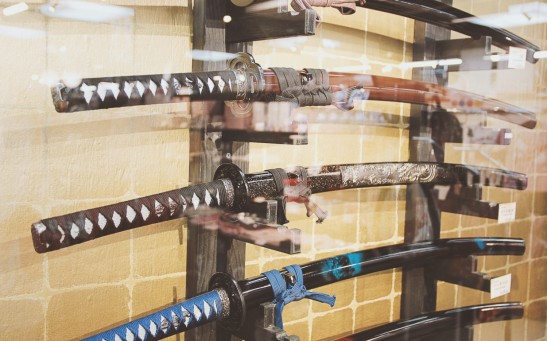 a display of different types of knives in a glass case