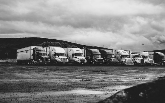 Parked Trucks Under Clouds